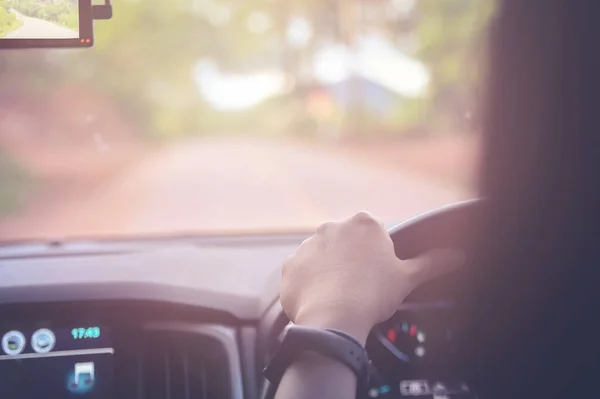 Hands Wheel Close Woman Driving Car Road Sunlight Warm Tone — Stock Photo, Image