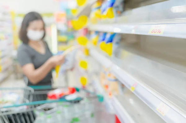 Empty shelves in a supermarket. Customers buy groceries and other items on stock. empty shops, sale up shop or panic shopping.