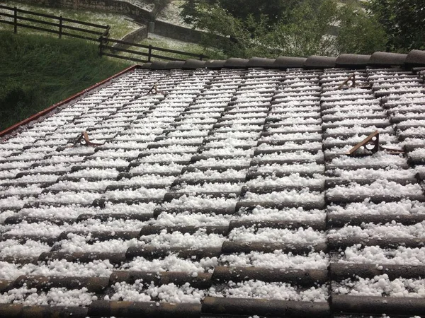 closeup of hail storm grains on a roof