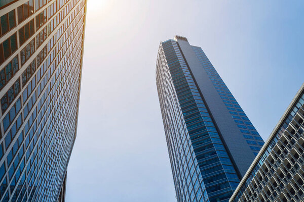 Looking up office buildings in Makati, Philippines. Bluish tint, financial/business theme background image