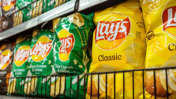 Manila, Philippines - July 2020: Lay's a popular brand of potato chips on display at an aisle in a supermarket.