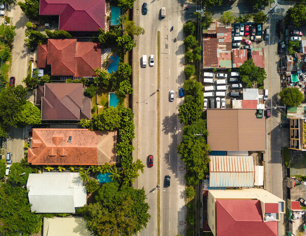 Las Pinas and Muntinlupa boundary separtaed by Daang Hari Road. Top view aerial of avenue.
