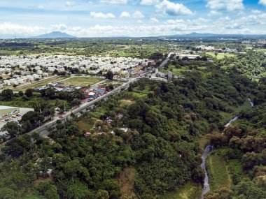 Aerial of Emilio Aguinaldo Highway and a nearby river in Dasmarinas Cavite. View of road that goes straight to Tagaytay clipart
