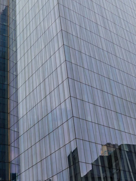 Closeup of reflective Glass cladding of an office building in Makati, Metro Manila.