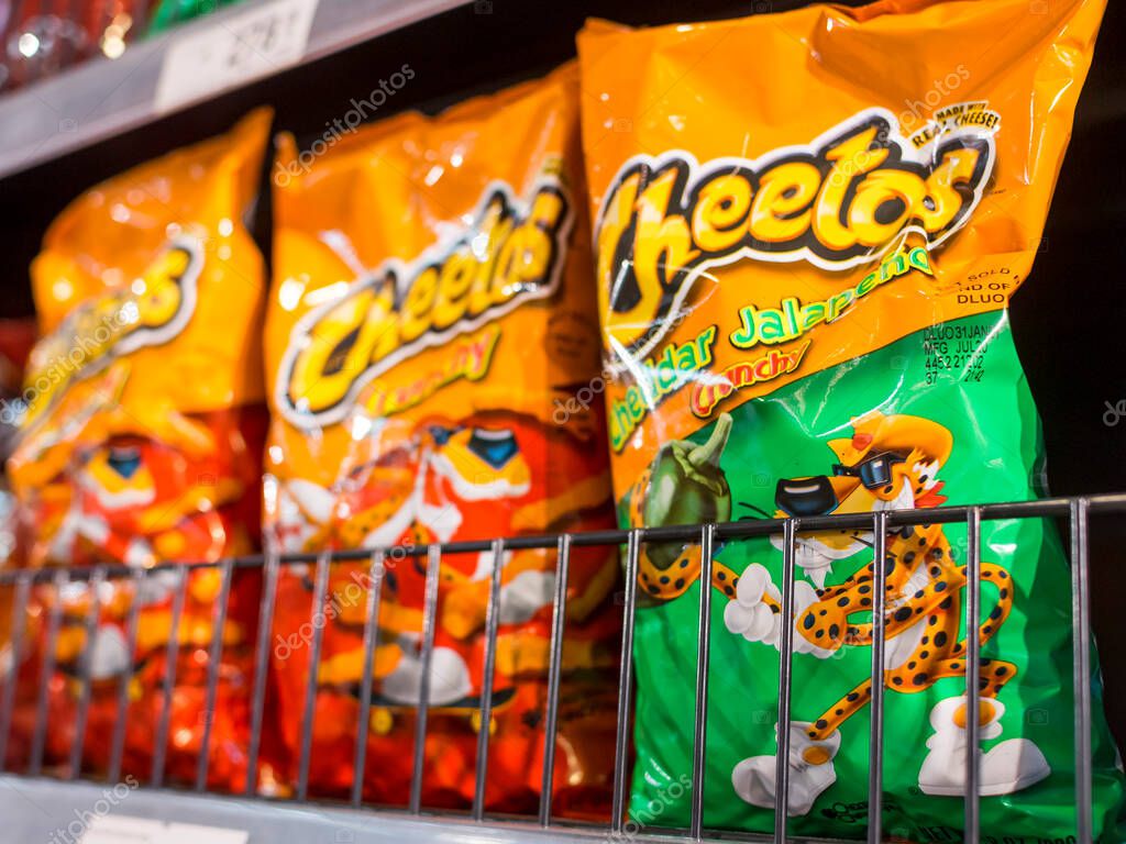 Manila, Philippines - Sept 2020: Cheetos is a brand of snacks made by Frito-Lay. Original and Cheesy Jalapeno flavors on an aisle at a supermarket.