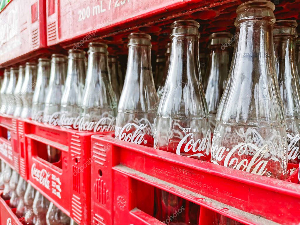 Manila, Philippines - October 2020: Empty 237 ml Coke bottles outside a local store.