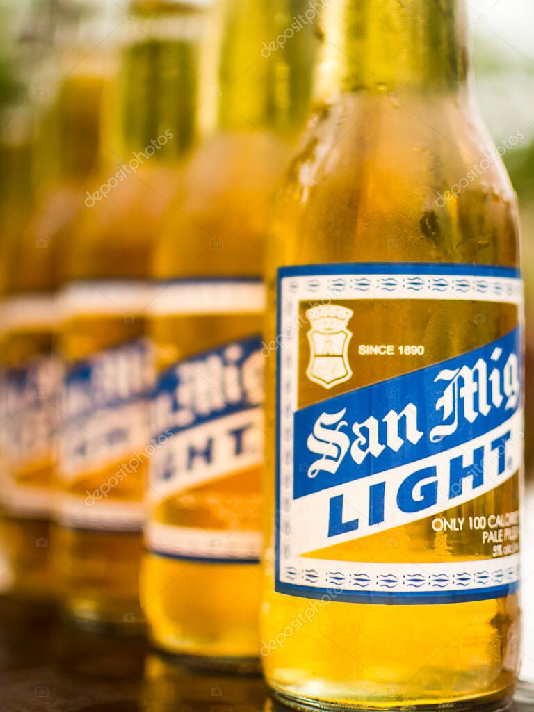 Manila, Philippines - June 2019: Closeup shot of a line of six cold San Miguel Light Beers.