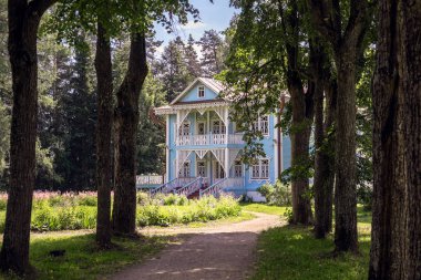 SHCHELYKOVO, KOSTROMA REGION /RUSSIA - JULY 22, 2018: Alley leading to the Blue House in the Museum-Reserve Shelykovo  clipart