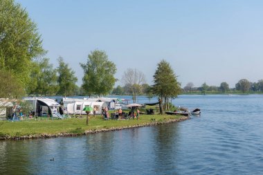 Kuzey Brabant/ Hollanda - 21 Nisan 2019: Meuse nehri kıyısında çadır ve karavanlarda dinlenin