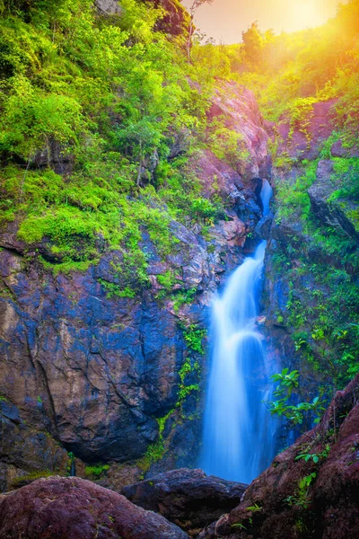 Beautiful waterfall with sunlight rays in deep forest, Landscape scenery of Jogkradin waterfall in Kanchanaburi, Thailand.