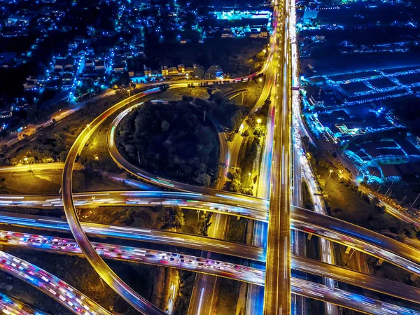 Aerial view of Circle Road traffic in roundabout and highway at night. Expressway, Modern transportation, Multilevel junction highway, Important infrastructure of transport in Thailand, Top view.