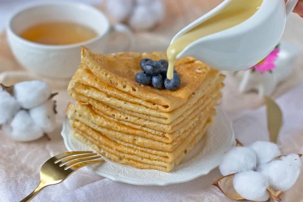 Stack Pancakes Blueberries Poured Condensed Milk Background Cup Tea Tablecloth — Stock Photo, Image