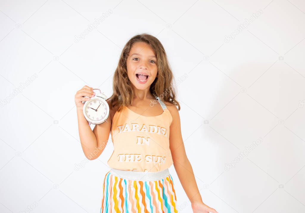 Beautiful girl with a clock on white background