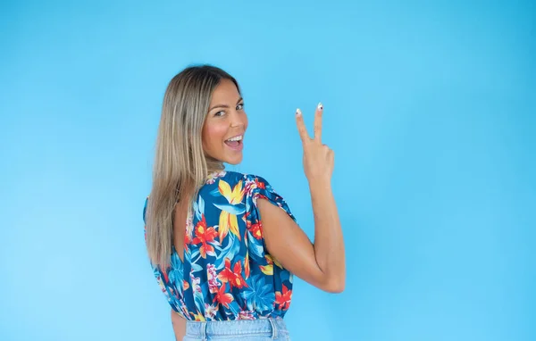 Blond Woman Victory Gesture Blue Background Smiling — Stock Photo, Image