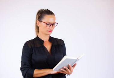 Beyaz arka planda defteri olan güzel bir iş kadını.