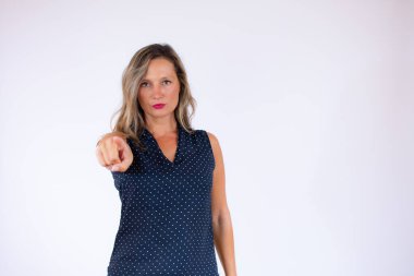 Mavi gömlekli kadın ciddi bir yüzü işaret ediyor.