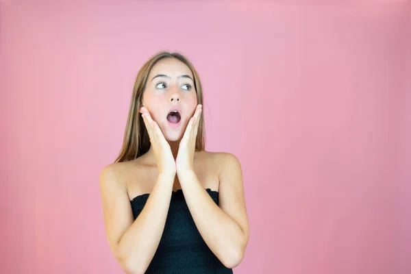 stock image Beautiful girl in black top with surprised gesture