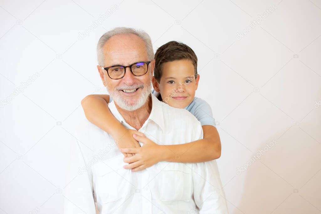 Senior man with glasses hugs his grandchild