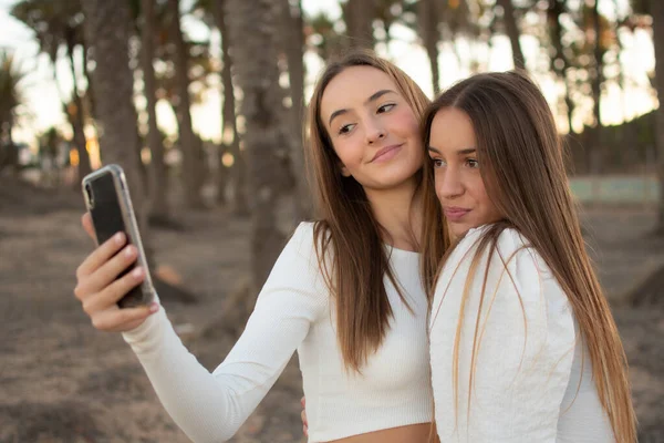 Dvě Šťastné Přítelkyně Dělat Selfie Parku Při Východu Slunce Teplým — Stock fotografie