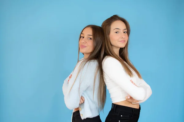 Portrait Two Teenage Girls Friends Arms Crossed Isolated Blue Background — Stock Photo, Image