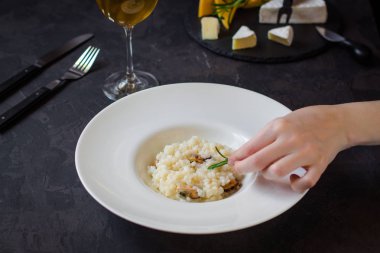 beyaz bir tabak ve bardak beyaz wineon karanlık bir arka plan risottowith midye (deniz ürünleri pirinç)