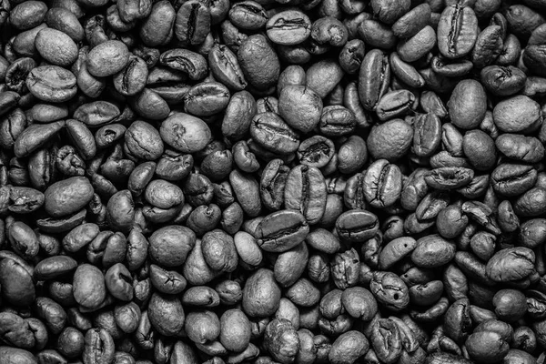 coffee grain (good and bad grain) - Arabica and Robusta blend (roasted coffee grain). Black background. Top view. Copy space.
