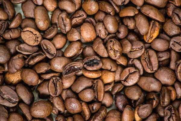 coffee beans (good and bad grain) - arabica and robusta blend (roasted coffee grain). Black background. Top view. Copy space.