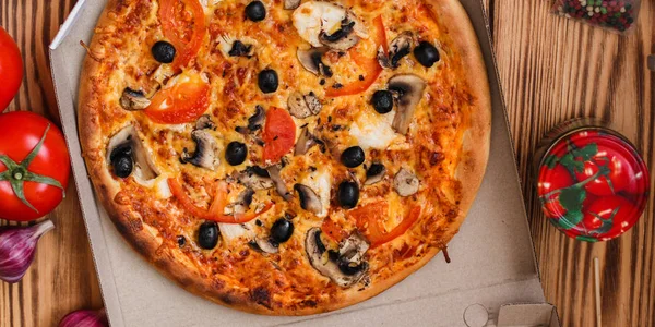 pizza, mushrooms, olives, chicken, tomato sauce, cheese, (pizza ingredients). hot pizza. Top view. copy space