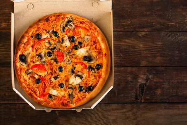 pizza, mushrooms, olives, chicken, tomato sauce, cheese, (pizza ingredients). hot pizza. Top view. copy space