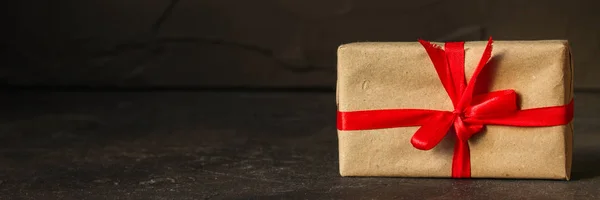 Gift Box, Ribbon - Kraft Paper(dark background). top view, copy spac