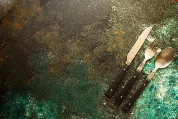 Cutleryrustic, used for eating or serving (fork, knife, spoon - set). food background. copy space — Stock Image Cutleryrustic Used Eating Serving Fork Knife Spoon Set Food Background Royalty Free Stock Images