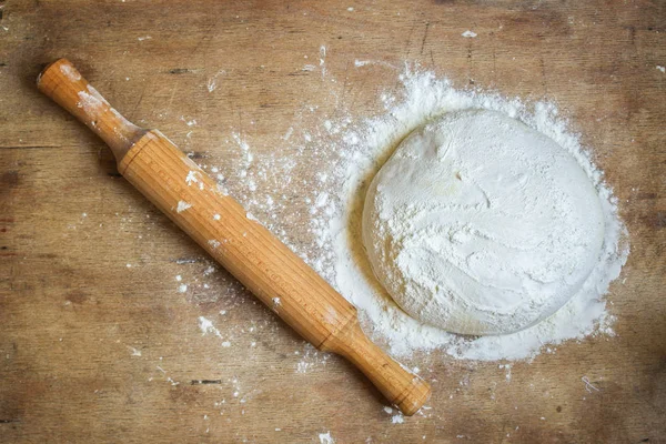 dough raw, flour, rolling pin for rolling (preparation for cooking) menu concept. food background. copy space