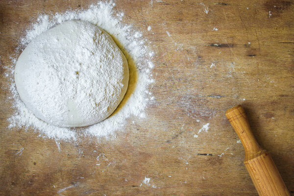 dough raw, flour, rolling pin for rolling (preparation for cooking) menu concept. food background. copy space