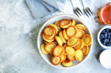 Mini gözlemeler, tatlı kahvaltı atıştırmalıkları veya servis edilen tatlı menüsü konsepti. organik sağlıklı beslenme için yiyecek arkaplanı üst görünüm kopyalama alanı