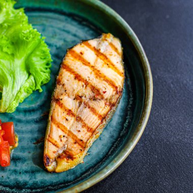 Kızarmış somon ızgarası. Salata, domates, arka plan. Sağlıklı keto ve paleo diyeti yiyen organik metinler için fotokopi alanı.