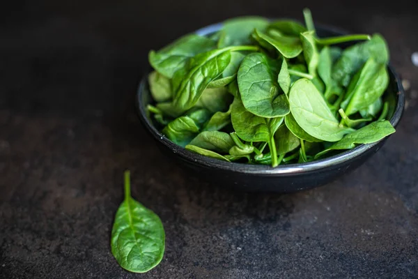 spinach salad green juicy leaves organic salad serving size natural top view copy space  for text diet raw food background rustic