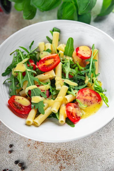 pasta salad tomato, arugula, boiled pasta fresh food tasty healthy eating cooking appetizer meal food snack on the table copy space food background rustic top view