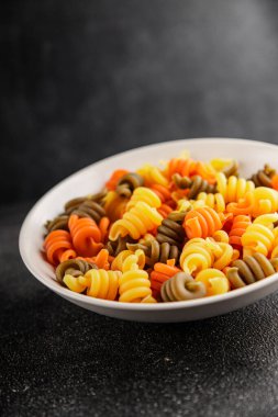 makarna trottole üç renkli makarna sarmalı bükülmüş İtalyan yemeği lezzetli çerez lezzetli gurme yemek arkaplan masa üzerinde rustik üst görünüm fotokopi alanı vegan ve vejetaryen gıda