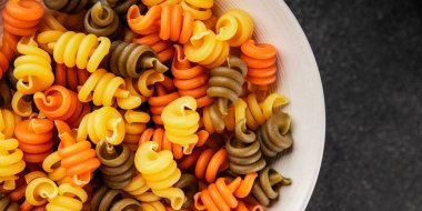 makarna trottole üç renkli makarna sarmalı bükülmüş İtalyan yemeği lezzetli çerez lezzetli gurme yemek arkaplan masa üzerinde rustik üst görünüm fotokopi alanı vegan ve vejetaryen gıda