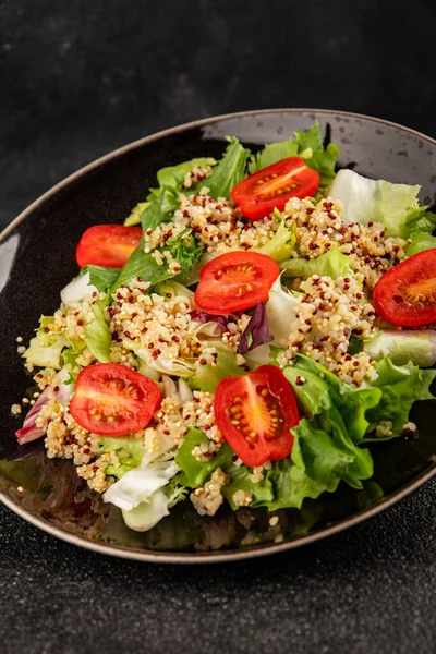Kinoa salatası domates, yeşil yaprak salatası sebzeler... doğal ürün... lezzetli çerez... lezzetli gurme yemek... masanın üstünde... rustik üst görünüm... fotokopi alanı keto... ve paleo diyet vegan ve vejetaryen yiyecekler.