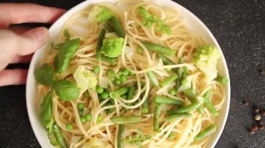 Spagetti sebzesi, bezelye, brokoli, çalı fasulyesi, kohlrabi vejetaryen makarna lezzetli makarna masanın üzerinde taze lezzetli gurme yemek.