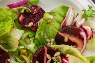 Beet salad green leaf lettuce vegetables natural product tasty snack fresh delicious gourmet food background on the table rustic top view copy space keto and paleo diet vegan and vegan food