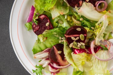 Beet salad green leaf lettuce vegetables natural product tasty snack fresh delicious gourmet food background on the table rustic top view copy space keto and paleo diet vegan and vegan food