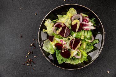 Beet salad green leaf lettuce vegetables natural product tasty snack fresh delicious gourmet food background on the table rustic top view copy space keto and paleo diet vegan and vegan food
