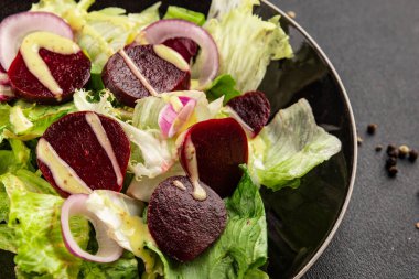 Beet salad green leaf lettuce vegetables natural product tasty snack fresh delicious gourmet food background on the table rustic top view copy space keto and paleo diet vegan and vegan food