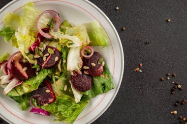 Beet salad green leaf lettuce vegetables natural product tasty snack fresh delicious gourmet food background on the table rustic top view copy space keto and paleo diet vegan and vegan food