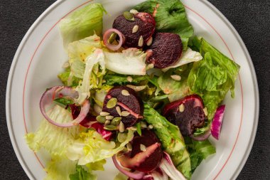 Beet salad green leaf lettuce vegetables natural product tasty snack fresh delicious gourmet food background on the table rustic top view copy space keto and paleo diet vegan and vegan food