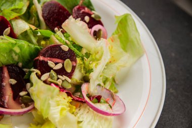 Beet salad green leaf lettuce vegetables natural product tasty snack fresh delicious gourmet food background on the table rustic top view copy space keto and paleo diet vegan and vegan food