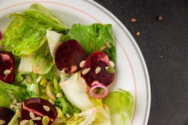 Beet salad green leaf lettuce vegetables natural product tasty snack fresh delicious gourmet food background on the table rustic top view copy space keto and paleo diet vegan and vegan food