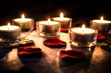 Kayrak gül yaprakları üzerinde 6 romantik Tealights ve yapraklar